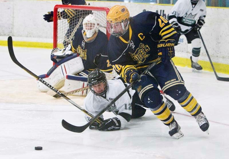 PUCK RETRIEVAL &#8211; St. Albert Raiders&#8217; captain Jason Miller goes for the puck in front of a fallen Nolan Krewusik of the Sherwood Park Kings in Sunday&#8217;s