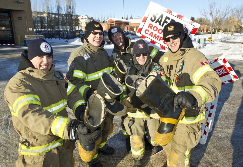 BOOT BUCKS – Firefighters started their annual rooftop campaign at Fire Station No. 2 last Wednesday morning. Pictured from left to right are: Adam Colameco