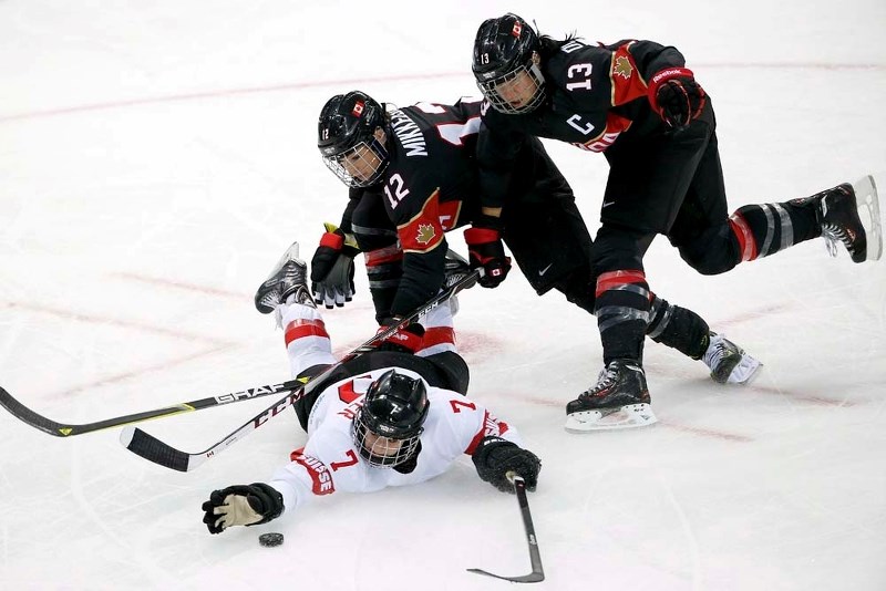 GAMES ON FOR MIKKELSON &#8211; St. Albert&#8217;s Meaghan Mikkelson and Team Canada captain Caroline Ouellette battle for control of the puck against Lara Stalder of