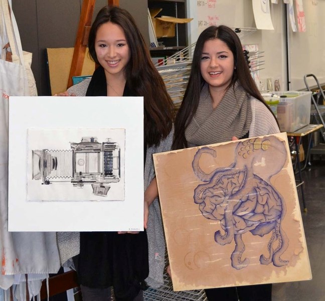 ON DISPLAY – Artist Kelsey Tamura (left) demonstrates her piece entitled XRay alongside Mariam Aljarah and her piece entitled Brain.