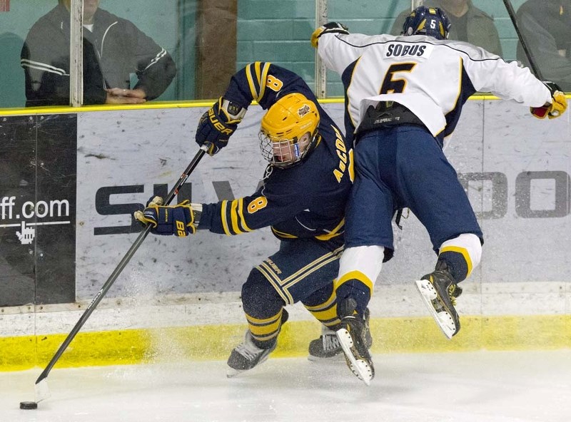CLOSE CALL &#8211; Parker AuCoin of the St. Albert Raiders avoids a check from Quinn Sobus of the Grande Prairie Storm on Monday in the last midget AAA game before the