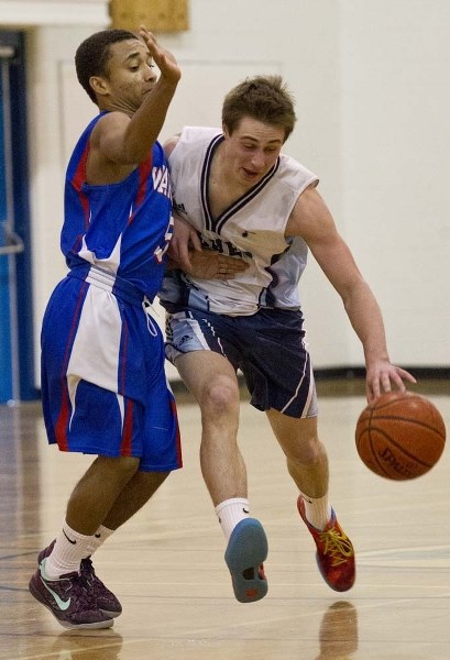 PUSHING THE BALL – Carter McKinley of the Paul Kane Blues drives past a W.P. Wagner defender in Monday&#8217;s 54-49 come-from-behind victory in the metro Edmonton division