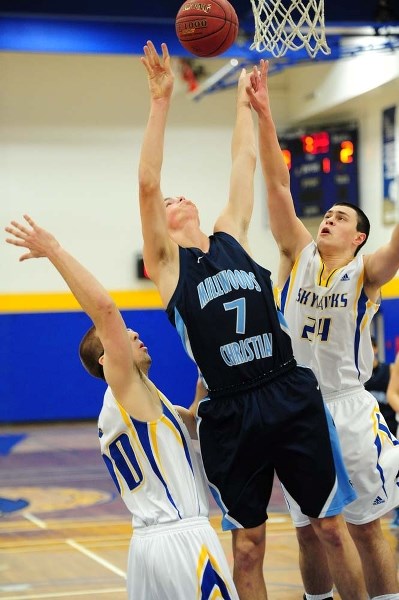 HANDS UP &#8211; Drew Bragg (left) and Andrew Salcedo of the St. Albert Skyhawks double-team the Millwoods Christian player in Thursday&#8217;s metro Edmonton division two