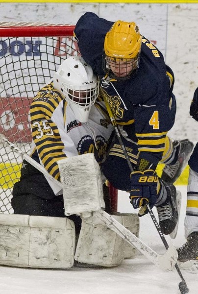 BUZZING THE NET &#8211; Kole Bryks of the St. Albert Raiders collides with netminder Joey Desrosiers of the Leduc Oil Kings in midget AAA playoff action Wednesday at