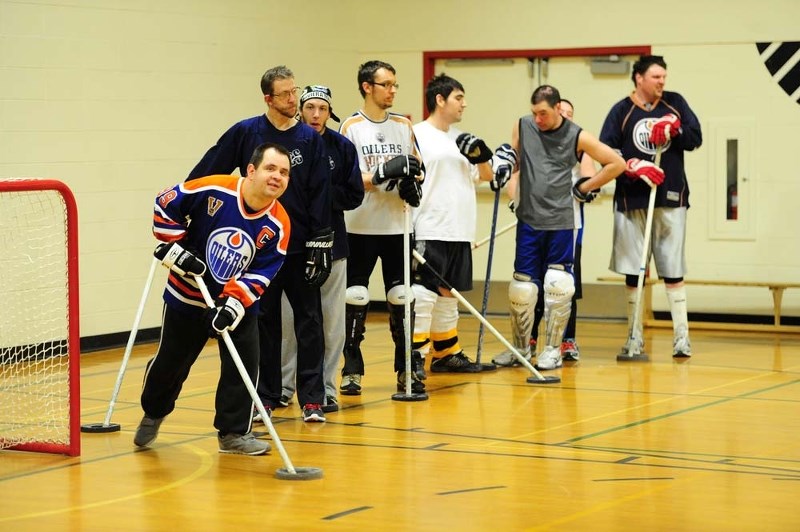 MEDAL CONTENDERS – Phil Zuk of the St. Albert Express B floor hockey team waits for his turn with the ring during Tuesday&#8217;s practice at Sir George Simpson School. The