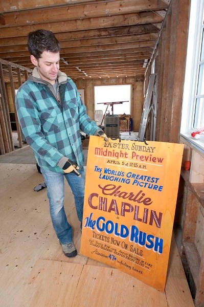 GREAT AD. BAD INSULATION – Energy efficiency expert Stuart Fix displays a 1940s-era movie poster he found in the walls of his Edmonton home during renovations. Homes from