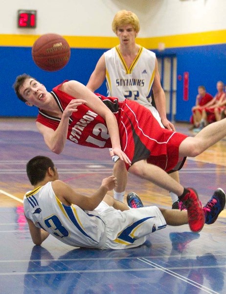 TRIPPED UP &#8211; Zane MacDonald of the Sturgeon Spirits dishes the ball off before tumbling to the floor in a collision with Leningrad Poserio of the St. Albert Skyhawks in 