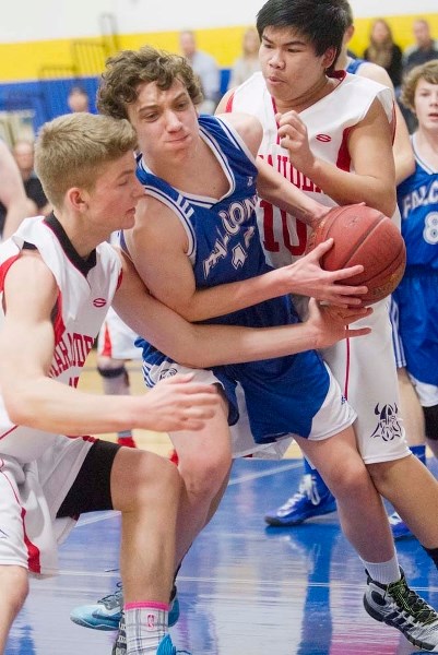 DOUBLE TEAMED &#8211; Ben Jones-Petrecca of the Richard S. Fowler Falcons is surrounded by Jake MacKay (left) and Raynard Dizon of the Vincent J. Maloney Marauders in the