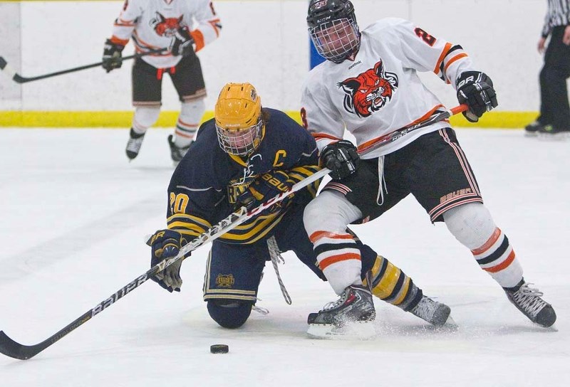 DIGGING DEEP &#8211; St. Albert Raiders co-captain Jason Miller battles Taylor Anshelm of the Lloydminster Bobcats for the puck in game four in the best-of-five midget AAA
