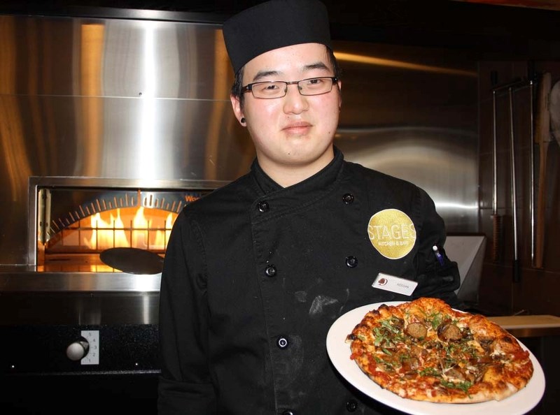 LUNCH IS READY – St. Albert student Keegan Yeo creates made-to-order pizza in less than five minutes at the new Stages Restaurant in the DoubleTree by Hilton Hotel in west