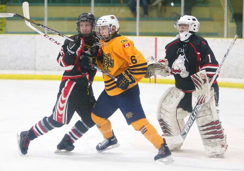 SCREENING THE GOALIE &#8211; Cam Mazur of the St. Albert Crusaders battles for positioning in front of Peace River Royals&#8217; netminder Jesse Pattison in game three in the 