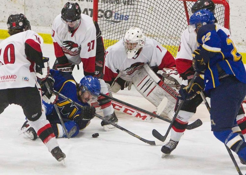 FOUNDERS CUP FINALE &#8211; Blair Macuch of the St. Albert Merchants battles for the puck while sprawled out on the ice in front of Trevor Dunstall (27) and netminder Tyler
