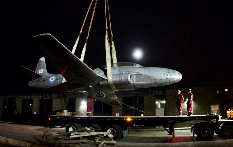 ON THE MOVE – The fighter plane in front of the St. Albert legion is lowered onto a flatbed truck for a move to a spot behind the Hemingway Centre downtown. The plane was