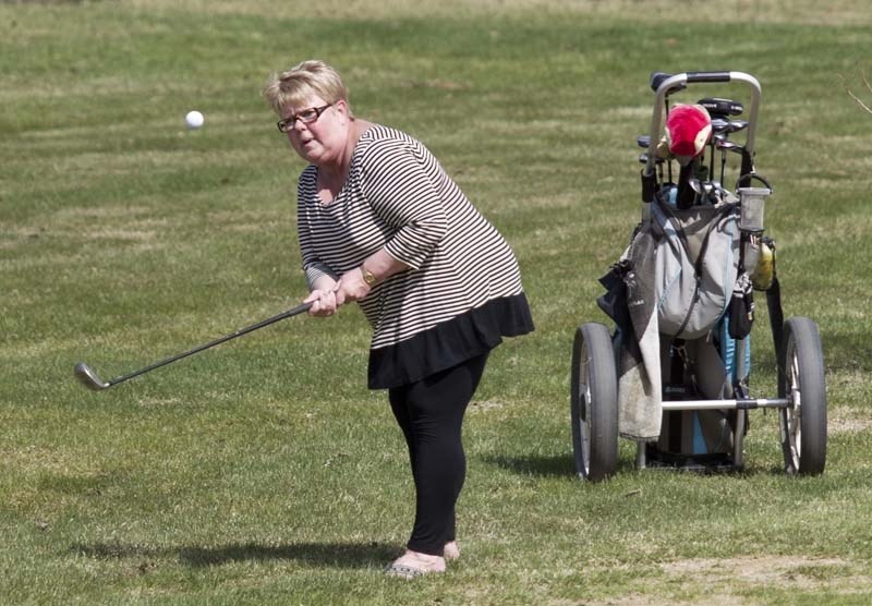 BALL STRIKER &#8211; Sandy Nixon takes advantage of Wednesday&#8217;s warm weather for a round of golf at the Twin Willows course. The 18-hole track consists of 45 bunkers