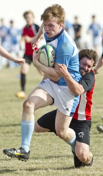 SQUEEZE PLAY &#8211; Connor McIntyre of the Paul Kane Blues is tackled from behind by Jake Farrell of the Sturgeon Spirits in Wednesday&#8217;s metro Edmonton division one