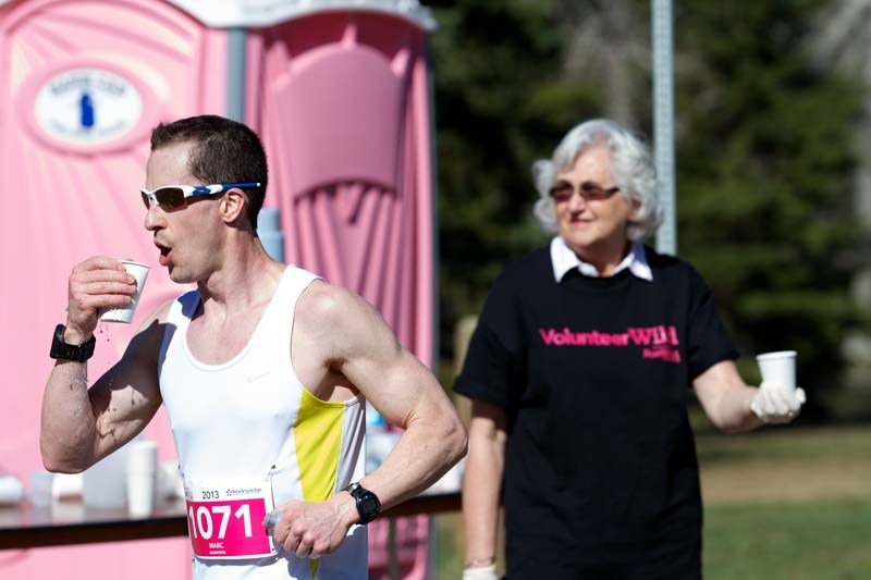 FUELING THE FIRE &#8211; Marc Meunier quenches his thirst while passing a water station during last year&#8217;s Leading Edge RunWild marathon in St. Albert. The Paul Kane