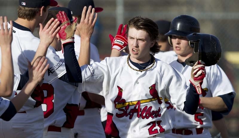 HIGH FIVES &#8211; Logan Harvey (front) and Evan Loranger of the St. Albert Cardinals receive high fives after scoring the first two runs in Wednesday&#8217;s 6-2 win over