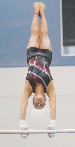 BALANCING ACT – Marisa Dick of St. Albert works on her uneven bars routine during Thursday&#8217;s training session at the Ortona Gymnastics Club. Last month Dick was the