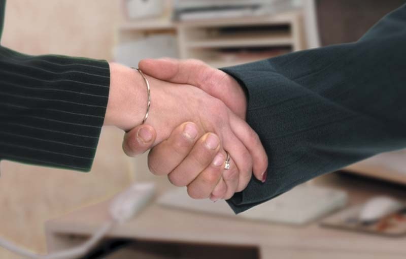 FIRM AND FRIENDLY – Research suggests a solid handshake not only contains confidence or aggression but can also say a lot about your chronological age.