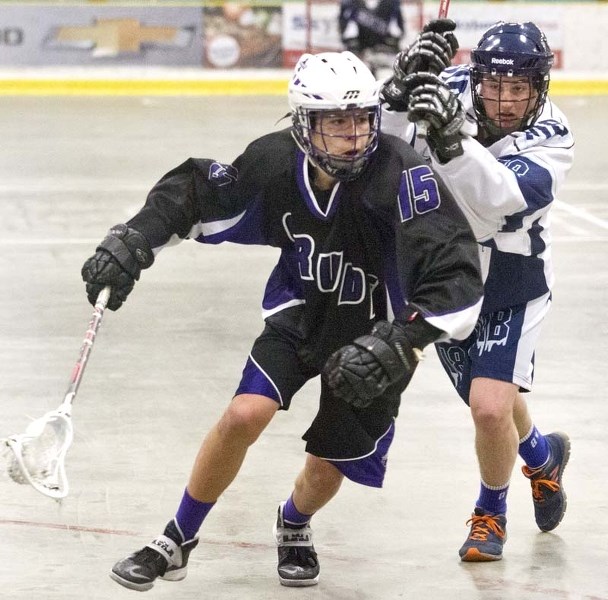 ATTACKER &#8211; Owen Feist of the St. Albert Crude runs with the ball while pressured by Kieran Mulvaney of the Winnipeg-based Manitoba Blizzard in Sunday&#8217;s junior B