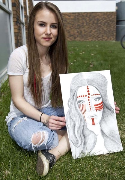 WINNING POSTER – Rachel Siffledeen shows off the poster that won the right to represent the city&#8217;s first Amplify Youth Festival next fall.