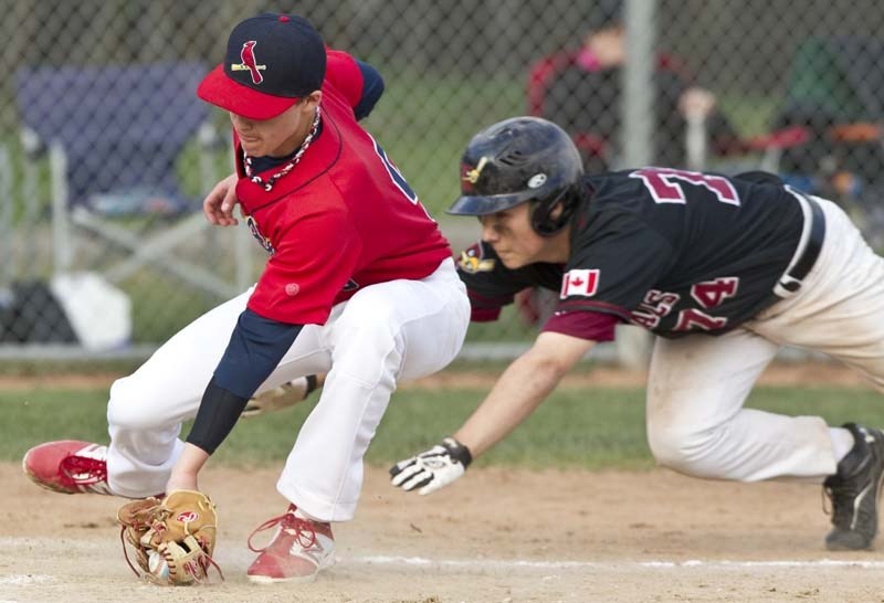 JUST A LITTLE LATE – St. Albert Bantam AAA Cardinals pitcher Zach Fromant is just a little late as he attempts to make the play at home plate during a Friday evening game at