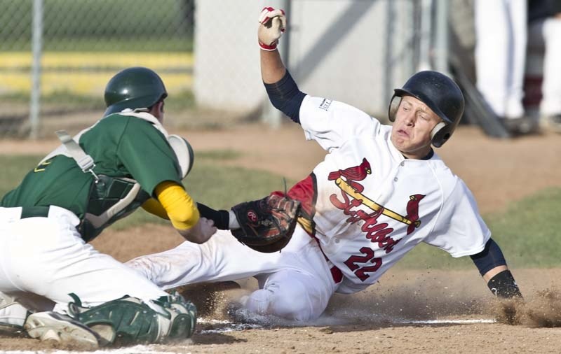 SLIDER – Matt Quartel makes a diving slide into home plate after leaving second base to score a run.