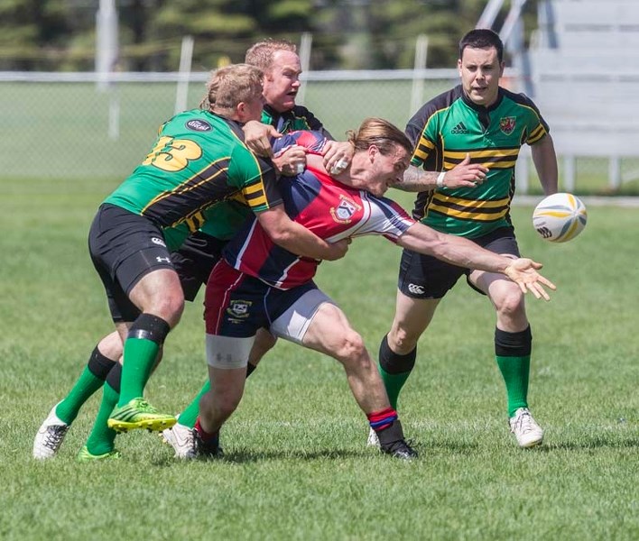 PLAYING THE BALL &#8211; Mitch Millett of St. Albert stretches to retrieve the ball while surrounded by the Lep/Tigers in Saturday&#8217;s Alberta Cup match. Millett scored