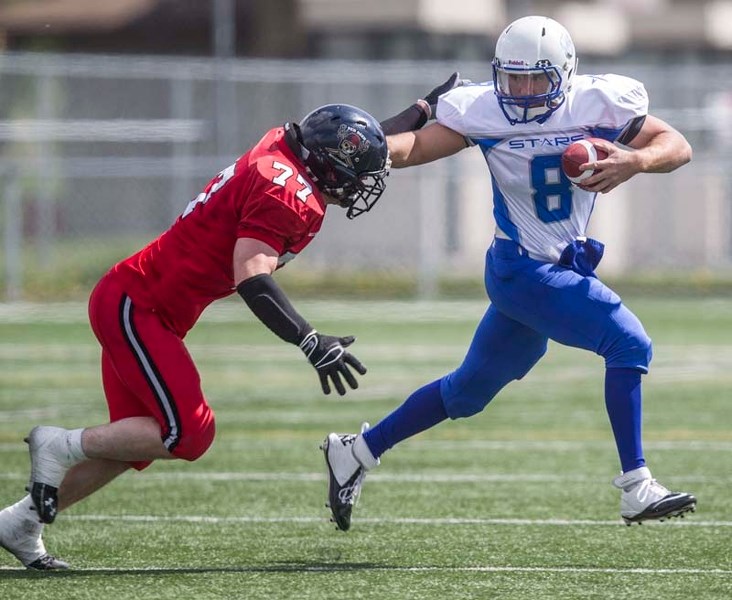 UNDER PRESSURE &#8211; St. Albert Stars quarterback Troy Pappas tries to fend off a defender in Saturday&#8217;s 26-12 Alberta Football League exhibition win over the Central 