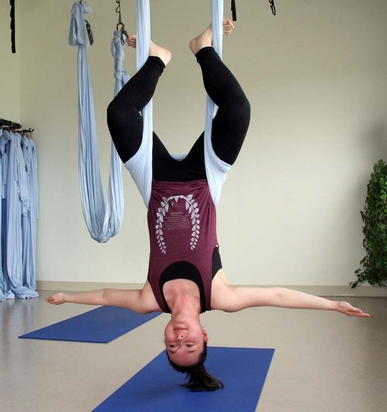 MONKEYING AROUND – Gazette reporter Amy Crofts defies gravity with an inverted monkey pose during a suspension yoga class at Soul Fitness Mind Body Studio.