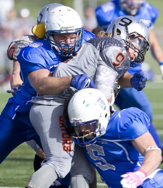 VISE GRIP &#8211; Korey Johnson (top) and Devin Guedo of the St. Albert Stars&lt;br /&gt;have Kurt Howland of the Calgary Gators locked in a tight squeeze in Saturday&#8217;s 