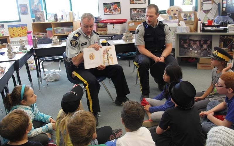 RESPECT YOUR ELDERS &#8211; Staff Sgt. Brent Mundle and Const. Steve Giavedoni read the book Wilfred Gordon McDonald Partridge