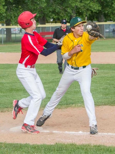 CLOSE CALL &#8211; Peter Corrigan of the St. Albert Cardinals arrives at first base as Shaun Atamanchuk of the Sherwood Park Athletics catches the ball in Tuesday&#8217;s