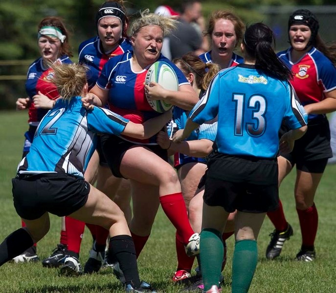 SPLITTING THE DEFENCE &#8211; Kiera Arndt of the St. Albert Rugby Football Club plows through the Parkland Sharks in Saturday&#8217;s 80-5 drubbing at Ellerslie Rugby Park.
