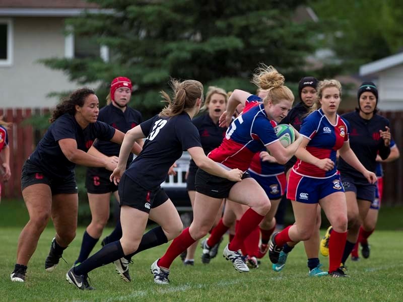 LEADER OF TRHE PACK &#8211; Michelle Marler of the St. Albert Rugby Football Club breaks away from the Clan in Wednesday&#8217;s match at Alpine field. The Clan won 46-14. It 
