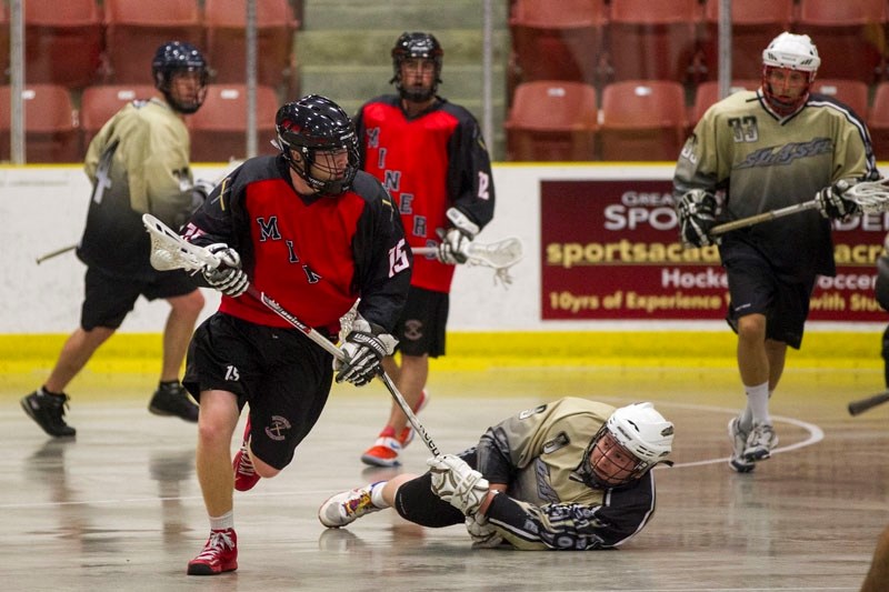 CRIMSON FLASH – Tom Buckley of the St. Albert Miners races past Calvin Roberts of the Spruce Grove Slash during first period action at the Northstar Hyundai Arena on July 2.