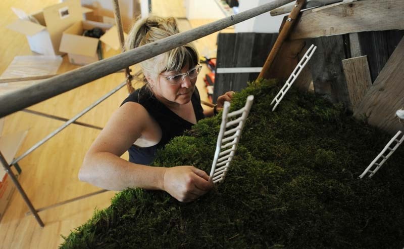 NATURE RETREAT – Sherri Chaba sets up her exhibit Retreat prior to its opening in late June. The artist will give an explanatory talk on Thursday