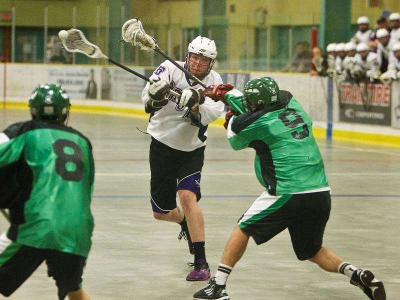 GRIP AND RIP &#8211; Cam Ellingson of the St. Albert Crude gets a shot away while harassed by Alex Kratz of the Saskatchewan Swat in game two in the best-of-three junior B