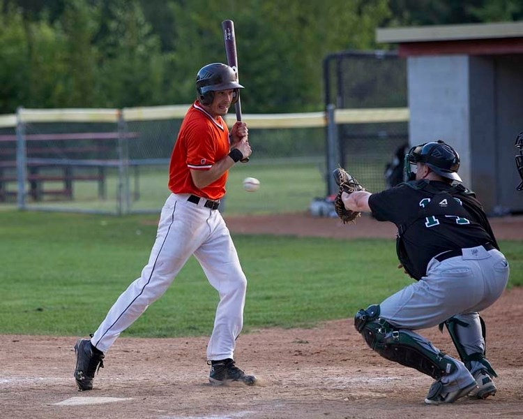 CLOSE CALL &#8211; Darren Adams of the St. Albert Tigers turns away from a wide pitch in front Fort Saskatchewan A&#8217;s catcher Matt Beaudry in Wednesday&#8217;s Sunburst