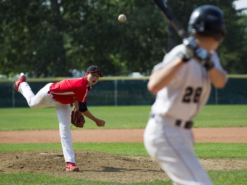 INCOMING &#8211; Tylor Jans of the St. Albert Cardinals delivers a pitch to Ben Erwin of the Spruce Grove White Sox in Saturday&#8217;s opening game at the Baseball Alberta