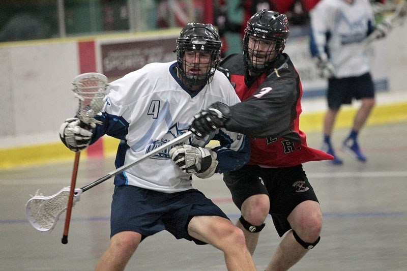 PLAYOFF CHALLENGE &#8211; Dalton Wassick of the Calgary Mountaineers keeps the ball away from Jarrett Toll of the St. Albert Miners in game two in the best-of-five senior B