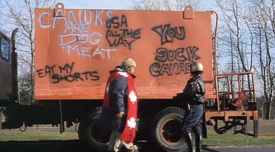 RCMP officer Dan Aykroyd schools American tourist John Candy on the higher principles of biliingual graffiti