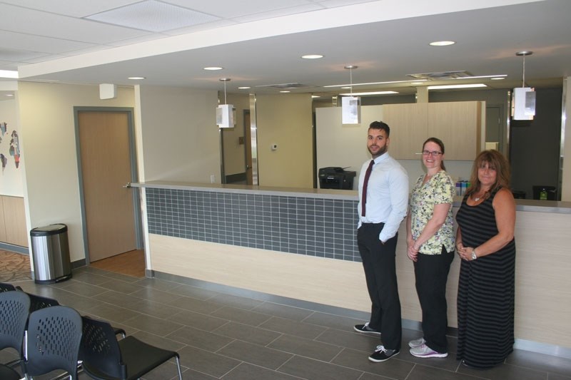 NEW PATIENTS WELCOME &#8211; (From left) Clinic business manager Houssam Sassi and medical office assistants Lori Anderson and Laurie Beley stand in front of the newly