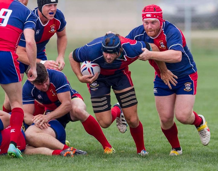 TEAMWORK &#8211; Isaac Foley of the St. Albert premier men&#8217;s team is supported by Paul Flynn while pushing forward with the ball in Saturday&#8217;s 32-22 victory over