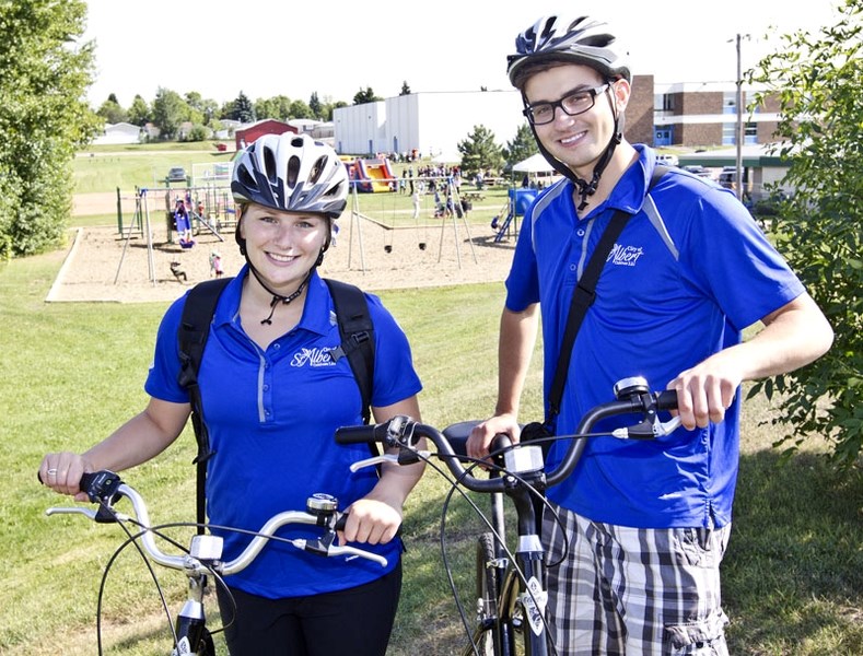 Summer students Kaitlyn Fenton and Jeremy Jakubowski are travelling on bikes riding around town doing public engaement on the &quot;Culvating Our Future&quot; community