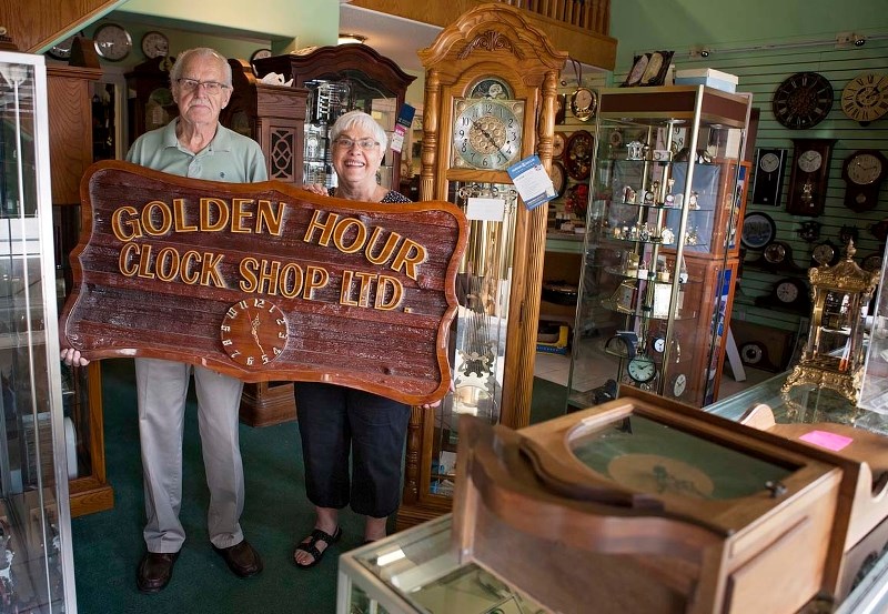 TIME MASTERS – St. Albert residents Hess (right) and Ronnie Nyenhuis show off a few of the hundreds of clocks and watches in their store in west Edmonton. The store