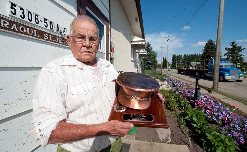 OFFICER ST. JEAN – Raoul St. Jean shows off the hat (now bronzed) he used to wear as Legal&#8217;s police officer in the 1950s. St. Jean was the town&#8217;s sole employee