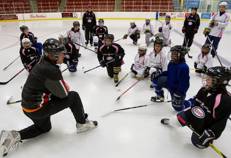 ICE CHATTER &#8211; Coach Darren Short talks hockey with young players during the on-ice skills event at Go Auto Arena during the ESSO female hockey fun day on Sunday. The