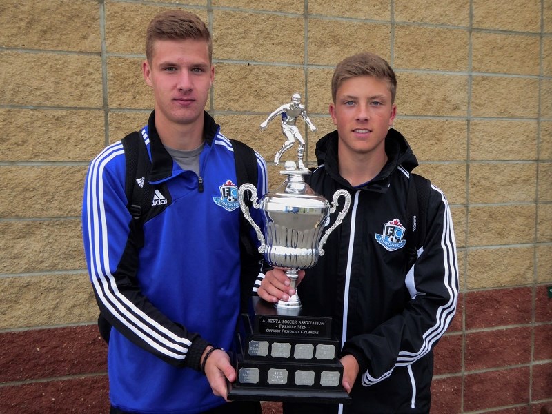 PREMIER CHAMPIONS &#8211; Noah Cunningham and Zach Rochat display the Alberta Soccer Association premier men&#8217;s championship trophy the FC Edmonton Academy team won last 