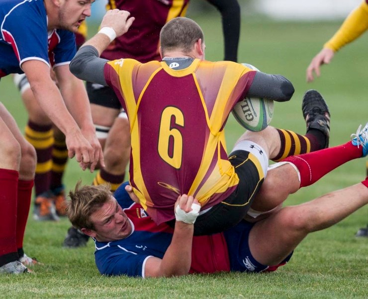 TAKEDOWN &#8211; Brett Clow of St. Albert pulls down a Nor&#8217;Wester with Rory Mitchell poised to steal the ball in Tuesday&#8217;s second division match at the St. Albert 